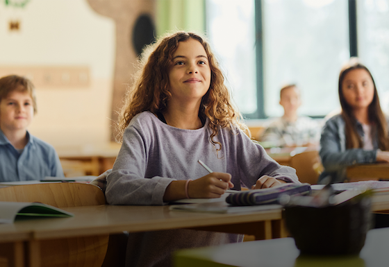 Young students smiling in class