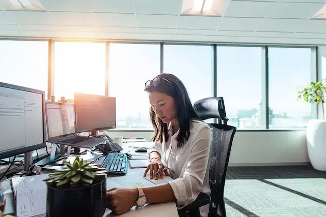 Woman sitting at desk in office.
